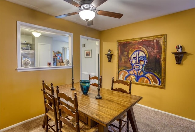 dining area with carpet floors, a ceiling fan, and baseboards