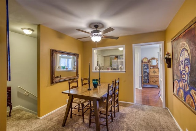 dining room featuring baseboards, carpet, and ceiling fan