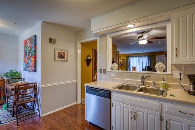 kitchen with stainless steel dishwasher, visible vents, light countertops, tasteful backsplash, and a sink
