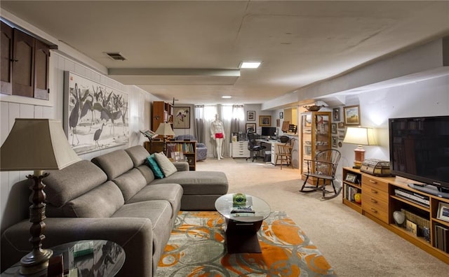 living area featuring light carpet and visible vents