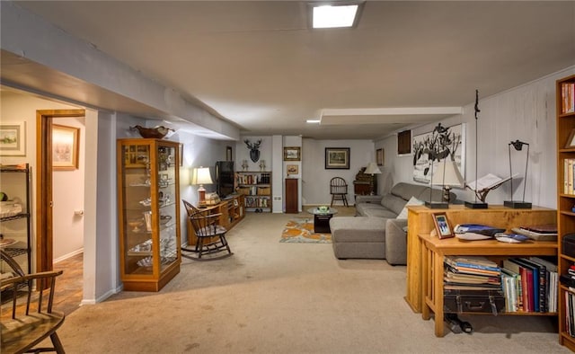 carpeted living area featuring baseboards