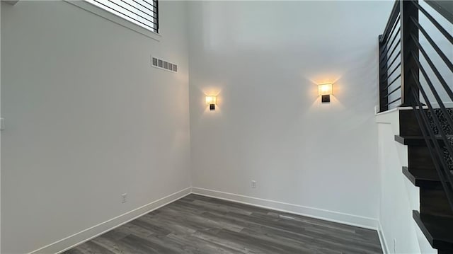 22146 W 116th Ter, Olathe, KS 66061 - interior space with visible vents, baseboards, a towering ceiling, and wood finished floors