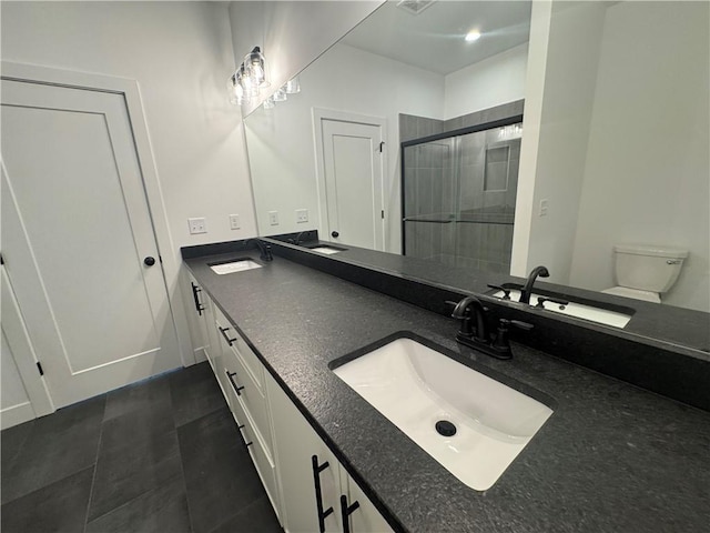 bathroom featuring a sink, a shower stall, and double vanity