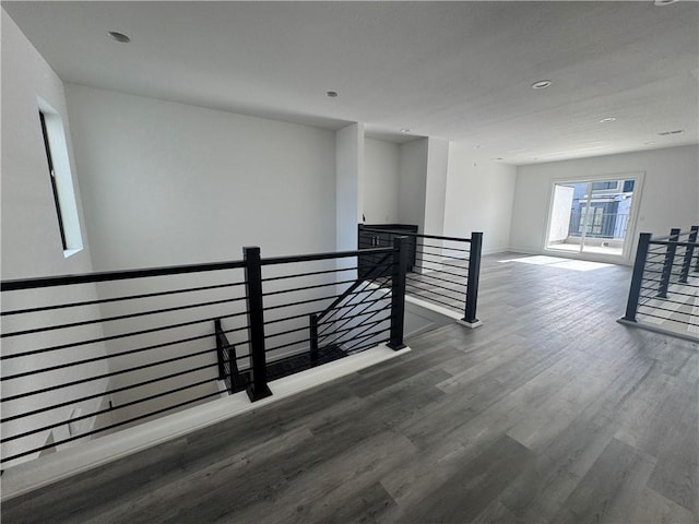 interior space featuring recessed lighting, baseboards, and wood finished floors