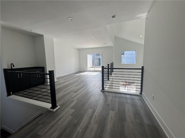 interior space with baseboards, recessed lighting, and wood finished floors