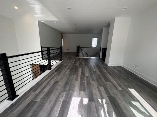 interior space with recessed lighting, baseboards, and dark wood finished floors