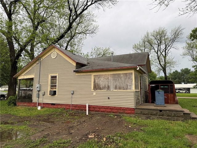 view of property exterior featuring crawl space, cooling unit, and roof with shingles