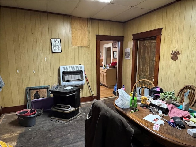 dining space with wood walls and heating unit