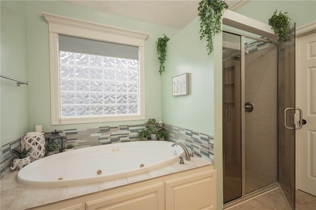 full bath featuring a jetted tub, tile patterned floors, and a shower stall