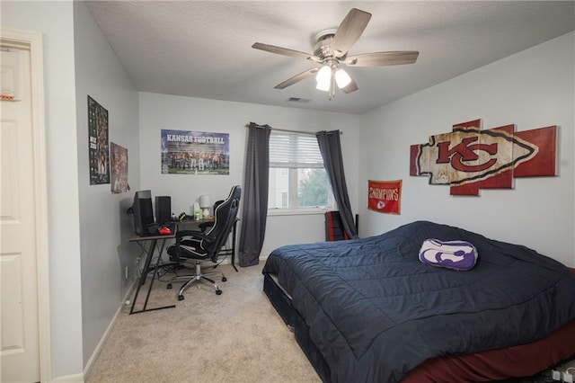 bedroom with carpet floors, ceiling fan, a textured ceiling, and visible vents