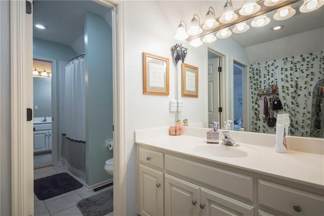 full bathroom with toilet, tile patterned flooring, and vanity