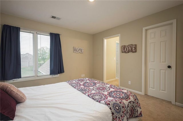 bedroom with carpet flooring, baseboards, and visible vents