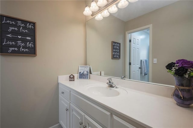bathroom featuring vanity and a chandelier
