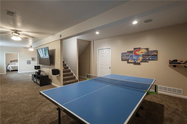 rec room with carpet floors, ceiling fan, baseboards, and visible vents