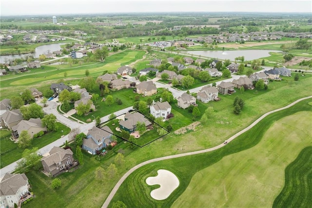 drone / aerial view with a water view, golf course view, and a residential view