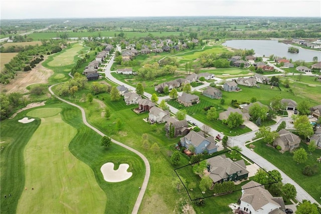birds eye view of property with a residential view, view of golf course, and a water view