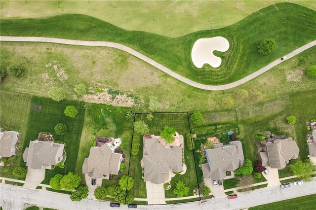 aerial view featuring view of golf course and a residential view