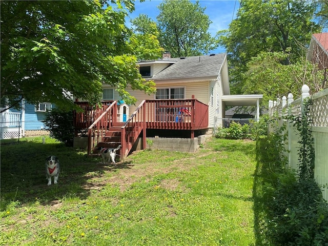 1404 S Barrett Ave, Sedalia, MO 65301 - back of property with fence, stairs, a deck, a chimney, and a lawn