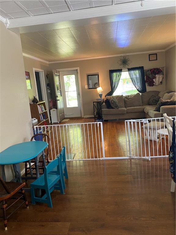 1404 S Barrett Ave, Sedalia, MO 65301 - living room with ornamental molding and wood finished floors