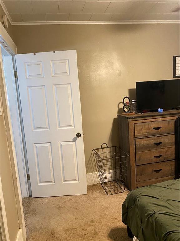 1404 S Barrett Ave, Sedalia, MO 65301 - carpeted bedroom with ornamental molding
