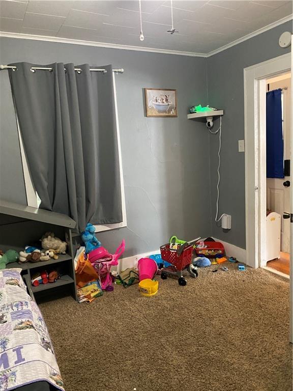 1404 S Barrett Ave, Sedalia, MO 65301 - unfurnished bedroom with carpet floors and ornamental molding