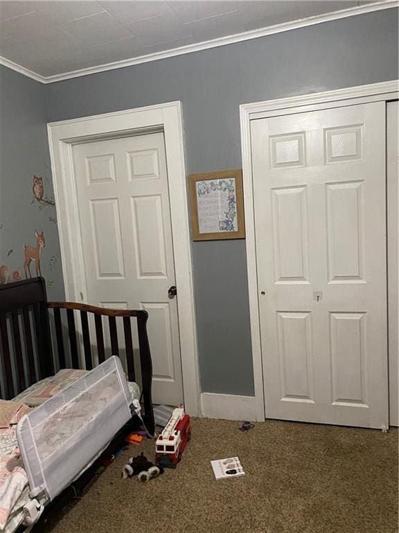 1404 S Barrett Ave, Sedalia, MO 65301 - bedroom with a closet, ornamental molding, and carpet flooring