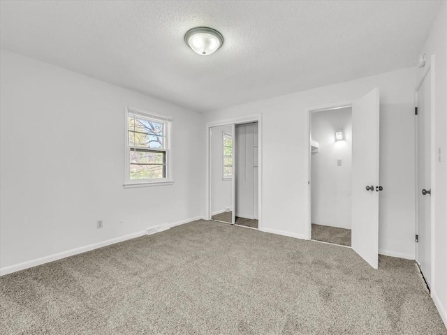 unfurnished bedroom with carpet floors, baseboards, a closet, and a textured ceiling