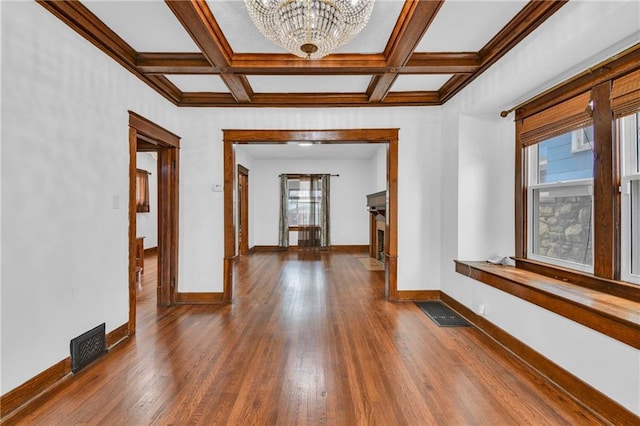 108 N Lawn Ave, Kansas City, MO 64123 - hall with visible vents, baseboards, plenty of natural light, and a notable chandelier