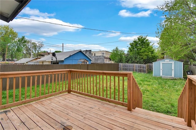 108 N Lawn Ave, Kansas City, MO 64123 - deck featuring a fenced backyard, an outdoor structure, a lawn, and a storage shed
