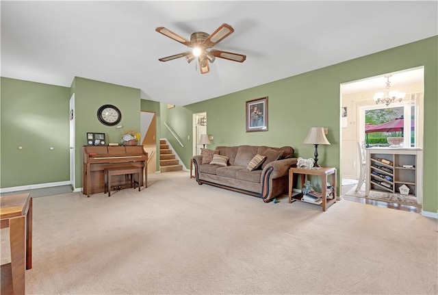 1003 Leone Ave, Sedalia, MO 65301 - carpeted living room with baseboards, stairs, and ceiling fan with notable chandelier