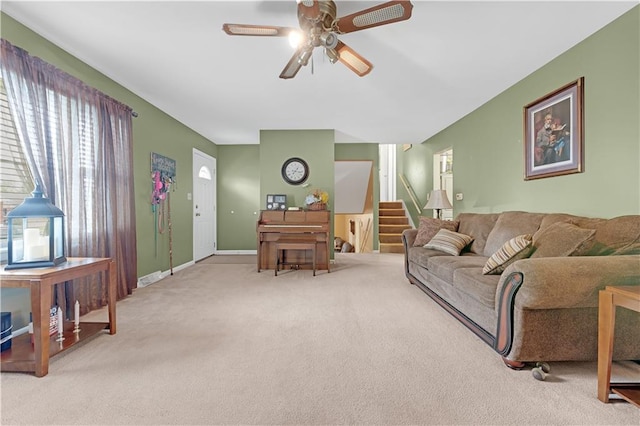 1003 Leone Ave, Sedalia, MO 65301 - carpeted living room featuring baseboards, a ceiling fan, and stairs