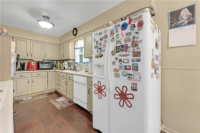 1003 Leone Ave, Sedalia, MO 65301 - kitchen with light countertops, a sink, dark wood-style floors, and white appliances