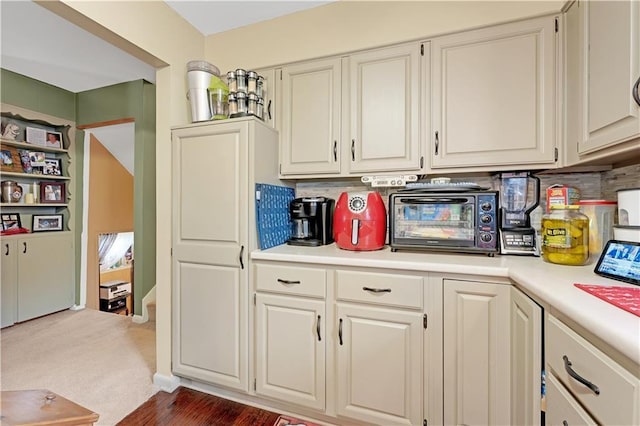 1003 Leone Ave, Sedalia, MO 65301 - kitchen featuring light countertops, white cabinetry, backsplash, and a toaster