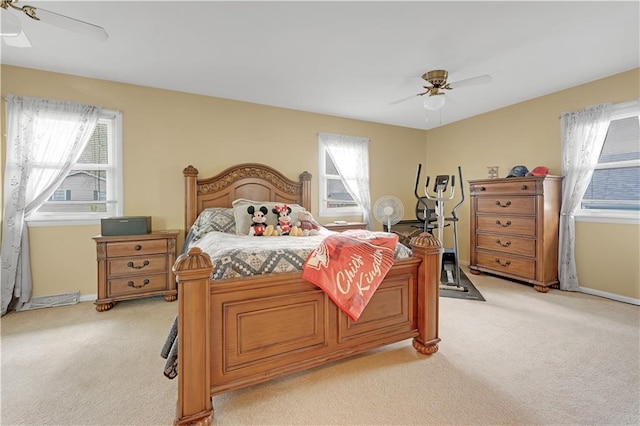 1003 Leone Ave, Sedalia, MO 65301 - bedroom with multiple windows, light carpet, and a ceiling fan