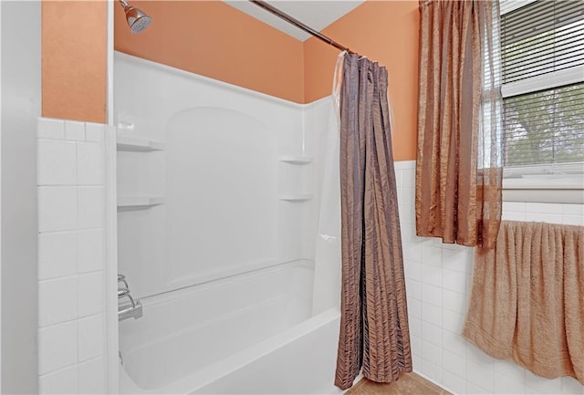 1003 Leone Ave, Sedalia, MO 65301 - bathroom featuring tile walls and shower / tub combo
