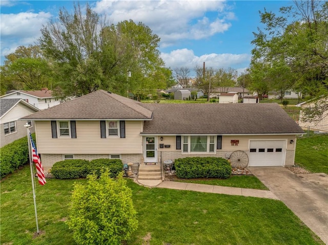 1003 Leone Ave, Sedalia, MO 65301 - tri-level home featuring concrete driveway, roof with shingles, a front yard, and a garage