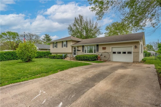 1003 Leone Ave, Sedalia, MO 65301 - split level home featuring an attached garage, driveway, and a front lawn