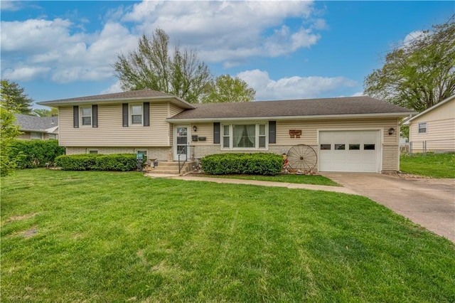 1003 Leone Ave, Sedalia, MO 65301 - tri-level home with concrete driveway, an attached garage, and a front lawn