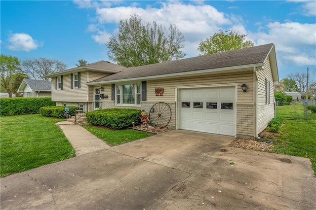 1003 Leone Ave, Sedalia, MO 65301 - split level home featuring driveway, a front yard, brick siding, fence, and an attached garage