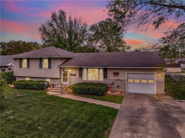 1003 Leone Ave, Sedalia, MO 65301 - split level home featuring a garage, concrete driveway, and a front lawn