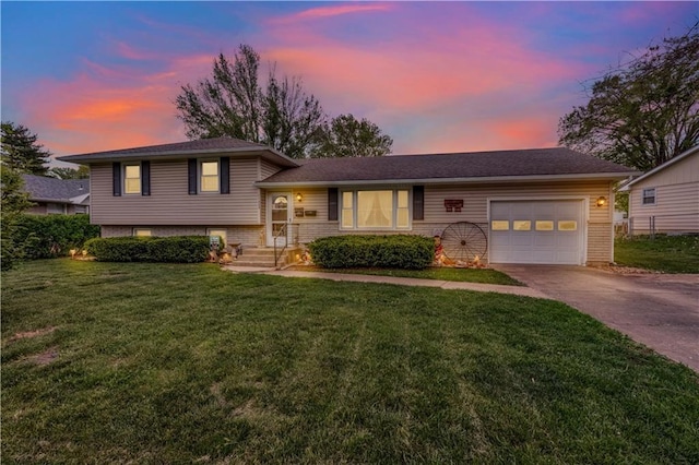 1003 Leone Ave, Sedalia, MO 65301 - tri-level home featuring a garage, a lawn, and driveway