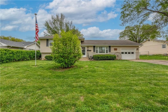 1003 Leone Ave, Sedalia, MO 65301 - split level home featuring concrete driveway, an attached garage, and a front yard