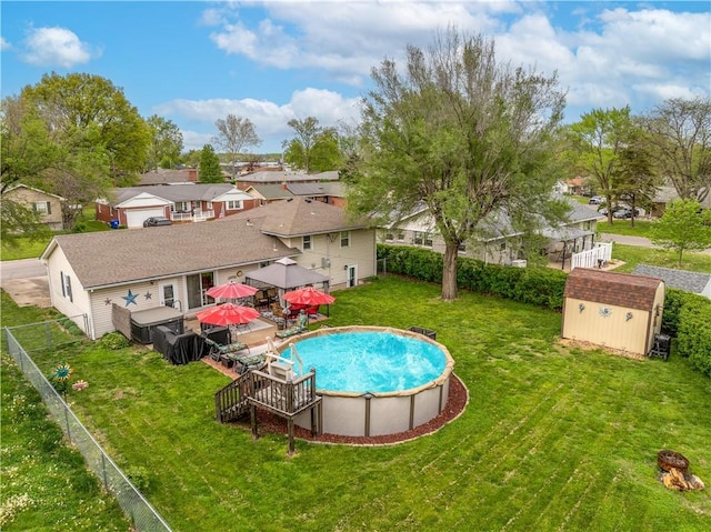 1003 Leone Ave, Sedalia, MO 65301 - pool with a storage shed, an outbuilding, a residential view, a fenced backyard, and a yard