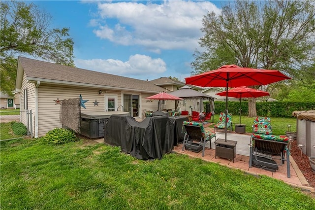 1003 Leone Ave, Sedalia, MO 65301 - back of property featuring a lawn, an outdoor living space, a hot tub, and a patio area
