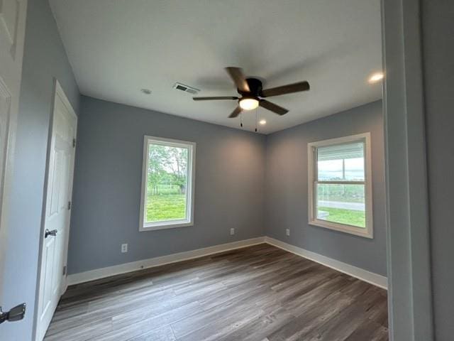 unfurnished room with wood finished floors, a ceiling fan, baseboards, and recessed lighting