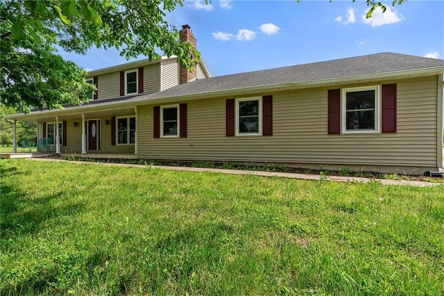 19707 E State Route A, Archie, MO 64725 - view of front of property with a chimney, a front yard, covered porch, and a shingled roof