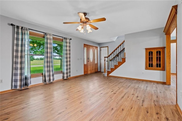 19707 E State Route A, Archie, MO 64725 - entrance foyer with wood finished floors, ceiling fan, stairway, and baseboards
