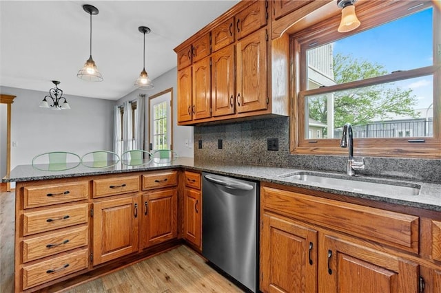 19707 E State Route A, Archie, MO 64725 - kitchen featuring dishwasher, a sink, a peninsula, and brown cabinetry