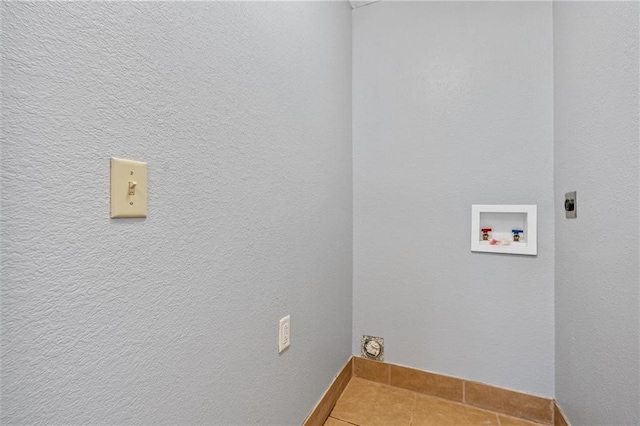 19707 E State Route A, Archie, MO 64725 - laundry room featuring electric dryer hookup, tile patterned floors, baseboards, and washer hookup
