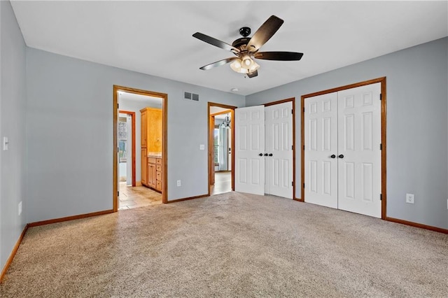 19707 E State Route A, Archie, MO 64725 - unfurnished bedroom with multiple closets, baseboards, and light colored carpet